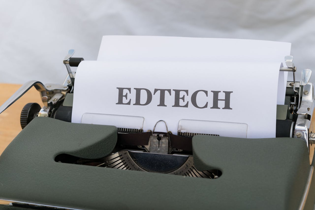 A vintage typewriter with a paper labeled EDTECH, signifying educational technology.